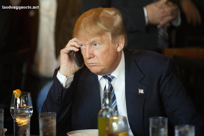 Republican presidential candidate Donald Trump listens to his mobile phone during a lunch stop, Thursday, Feb. 18, 2016, in North Charleston, S.C. (AP Photo/Matt Rourke)